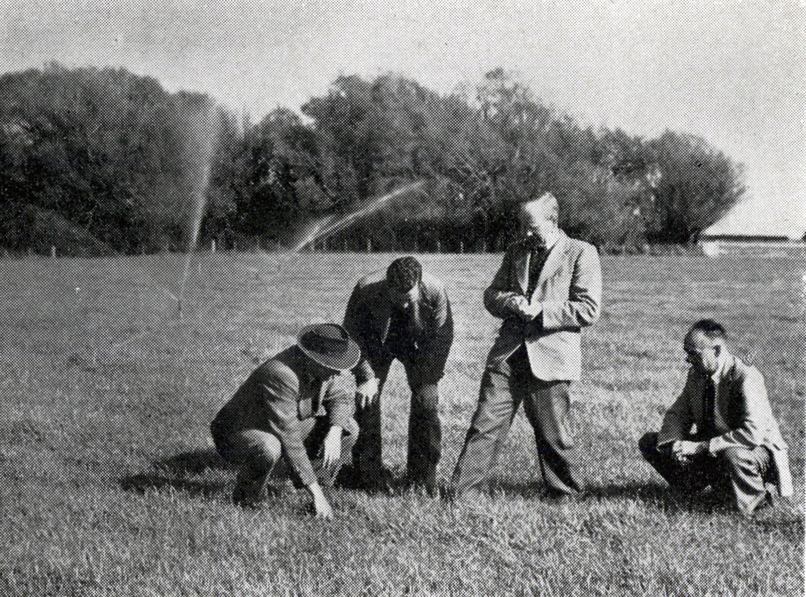 1954 College staff inspect pasture irrigated by the sprinkler system