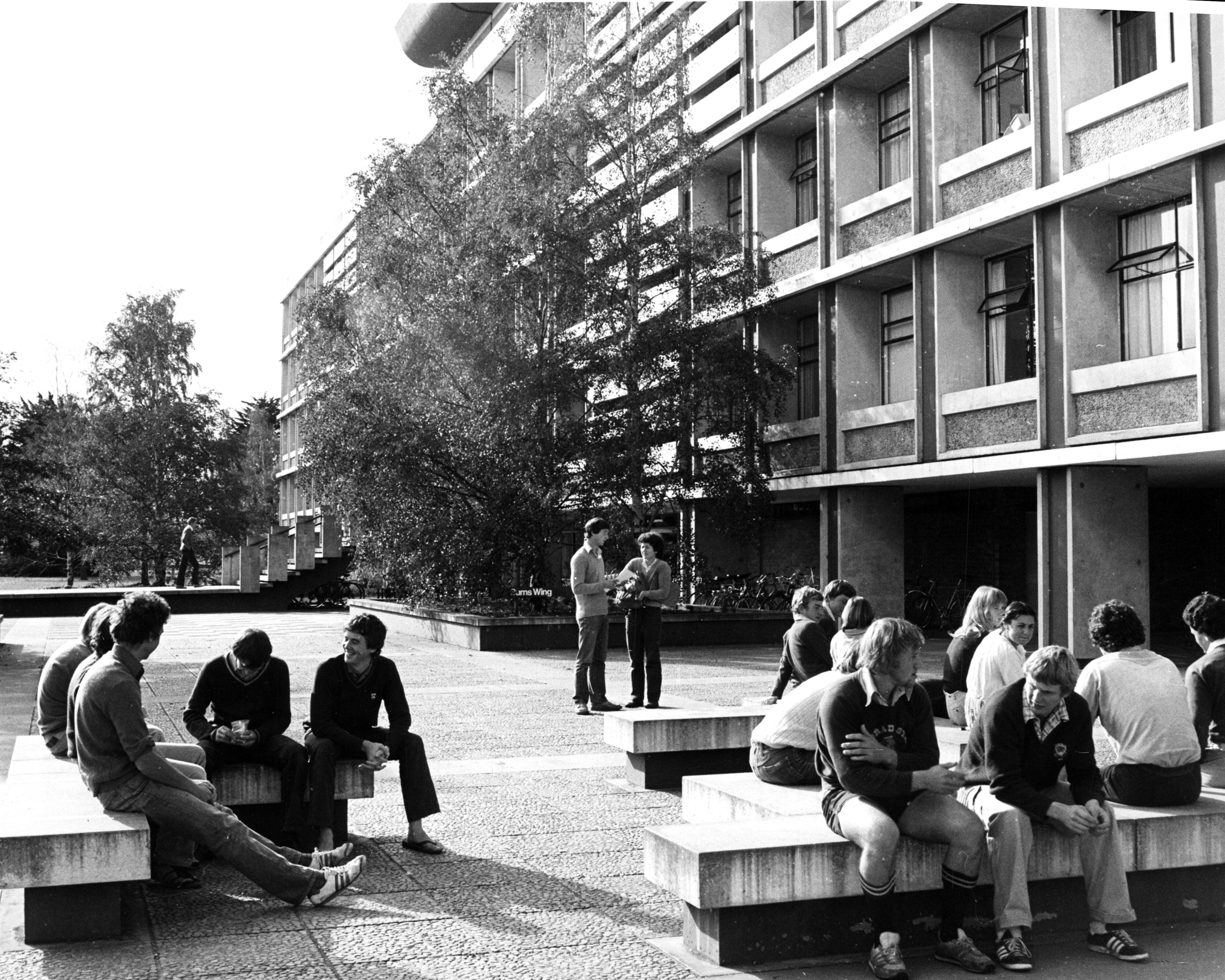 1970s Lincoln College students relaxing in front of the Hilgendorf Building