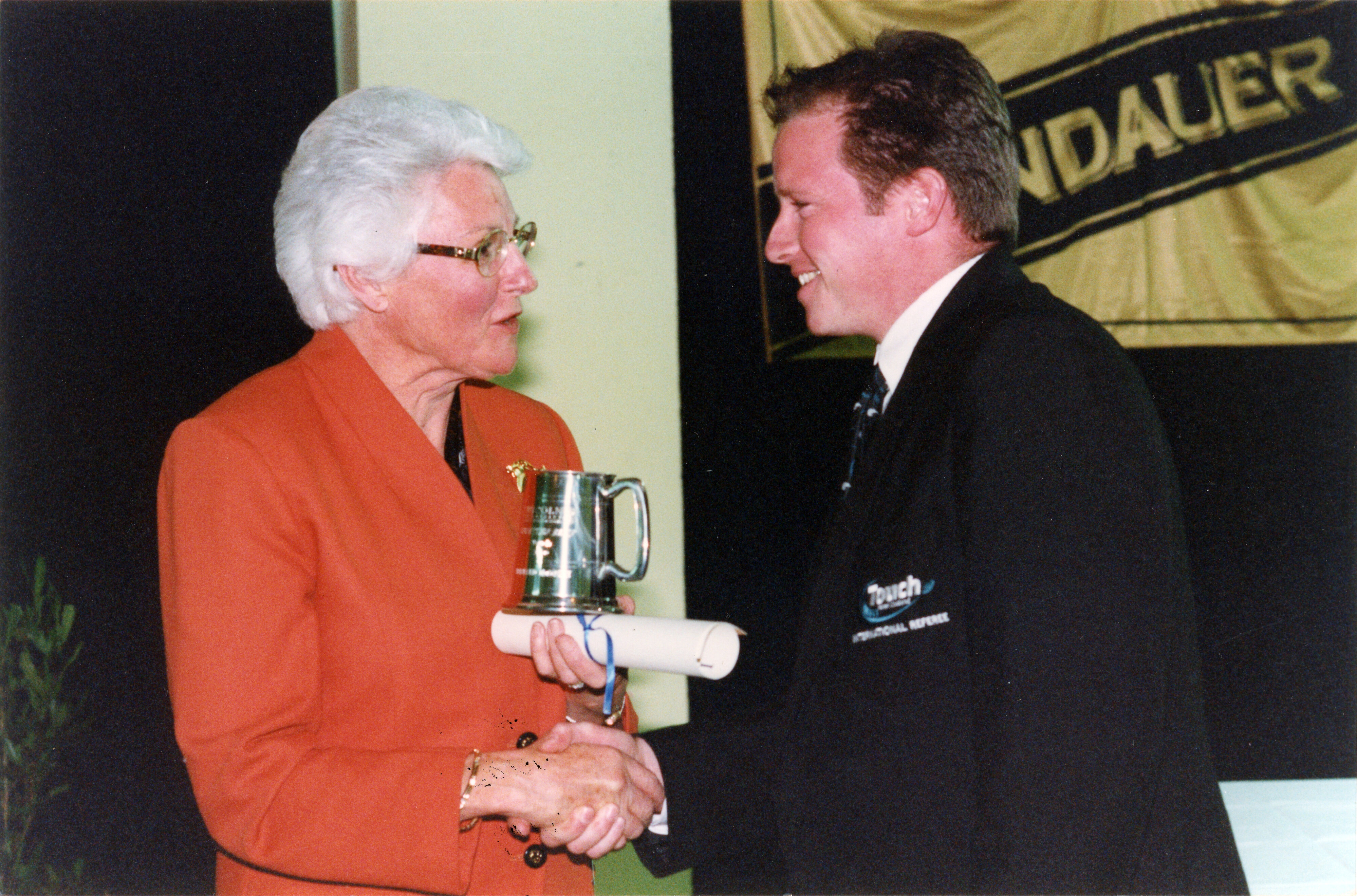 Bernard McDrury receiving his Lincoln Blue from Margaret Austin, September 2000