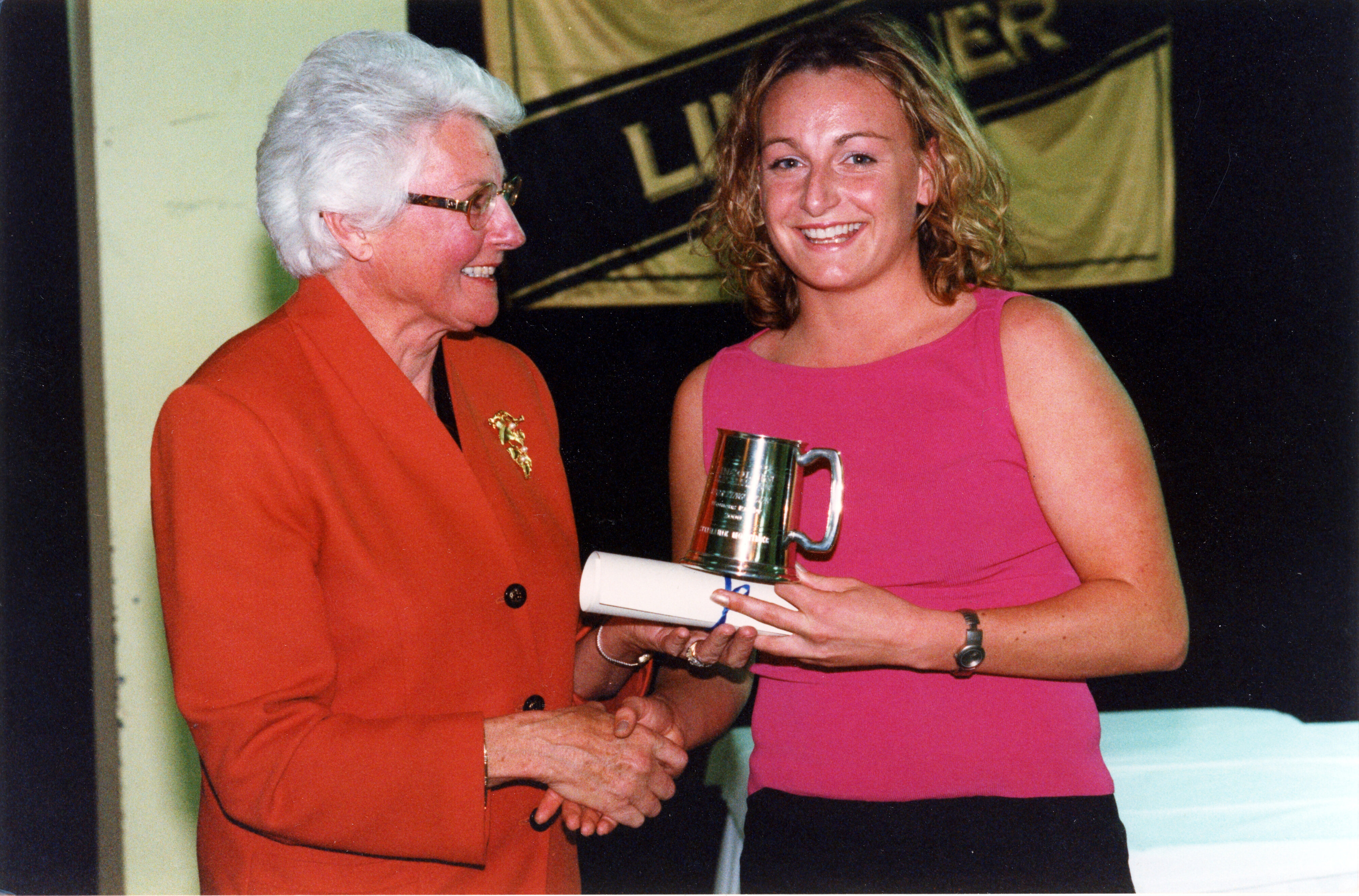 Margaret Austin congratulates Stephanie Mortimer on her blue in rugby, September 2000