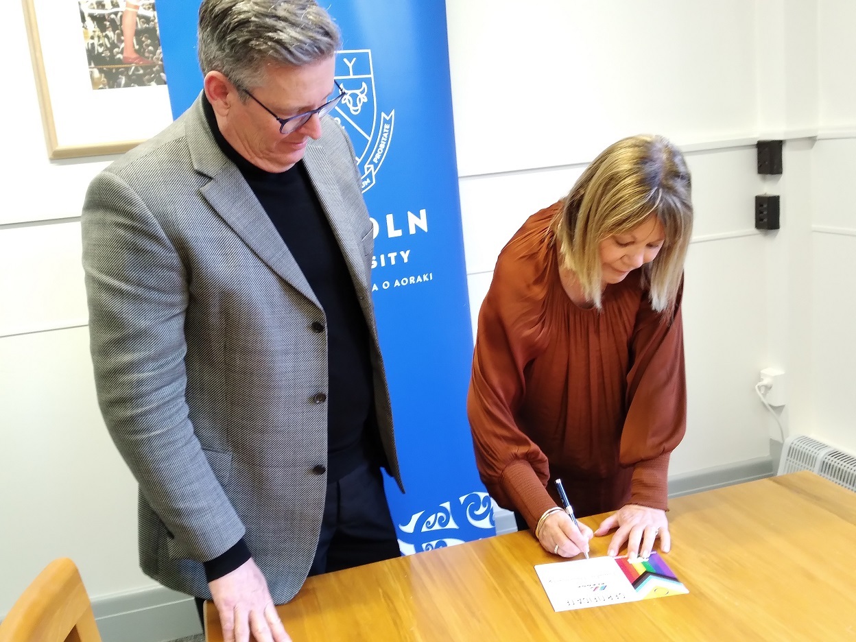 Damian Lodge and Karen McEwan signing Pride Pledge certificates, 2024