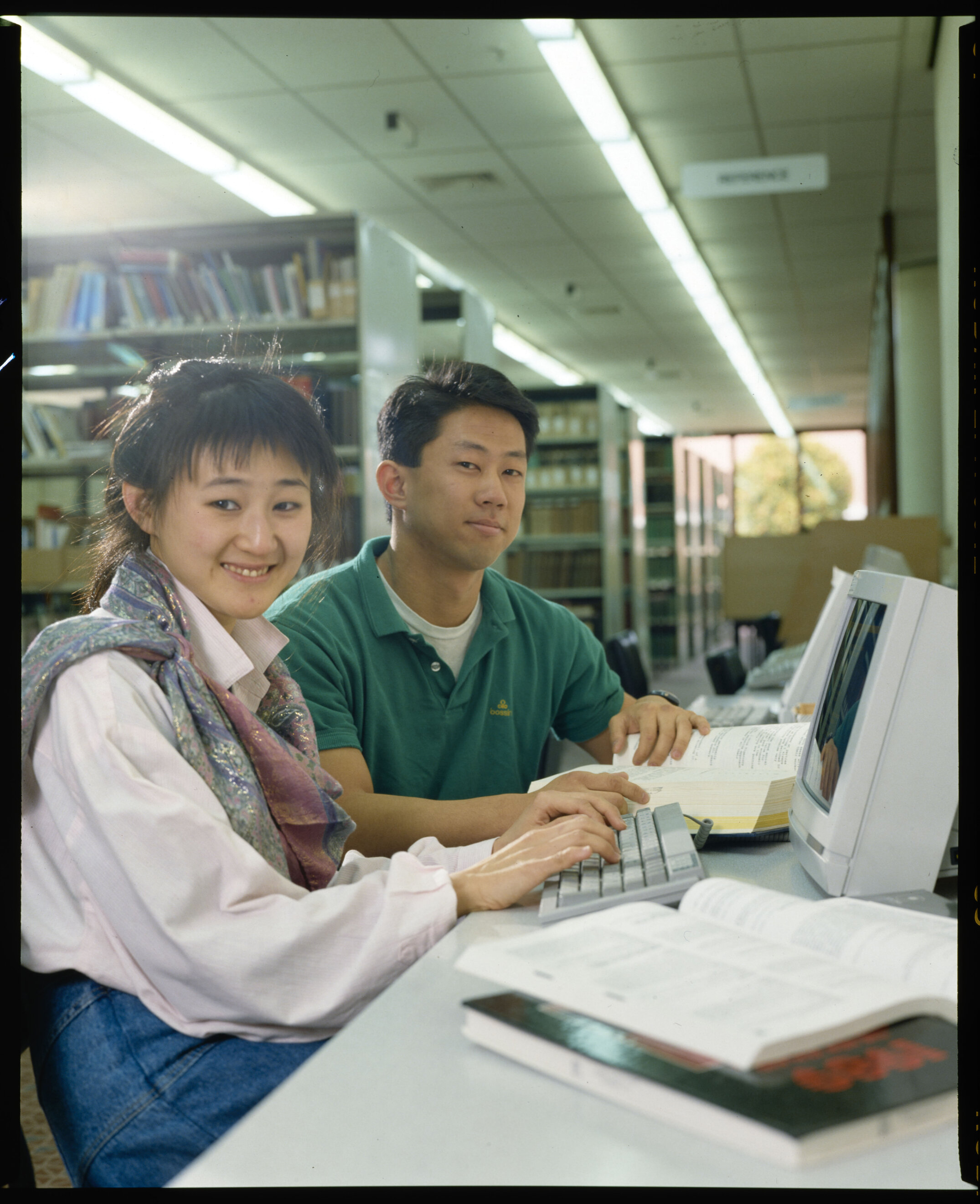 Students in the 1990s using a computer in the library
