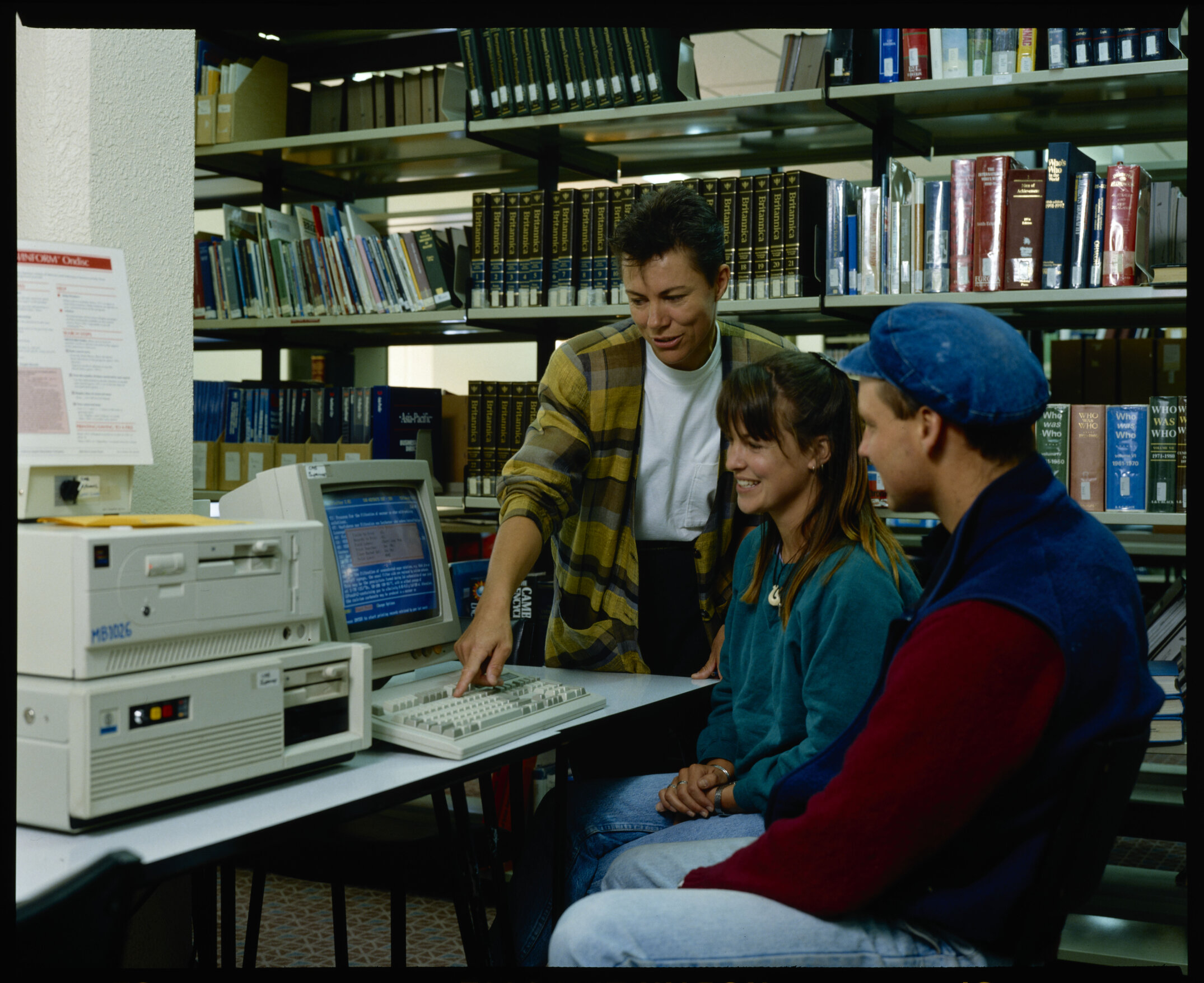 Late 1980s or early 1990s, students working on the computer in the Library