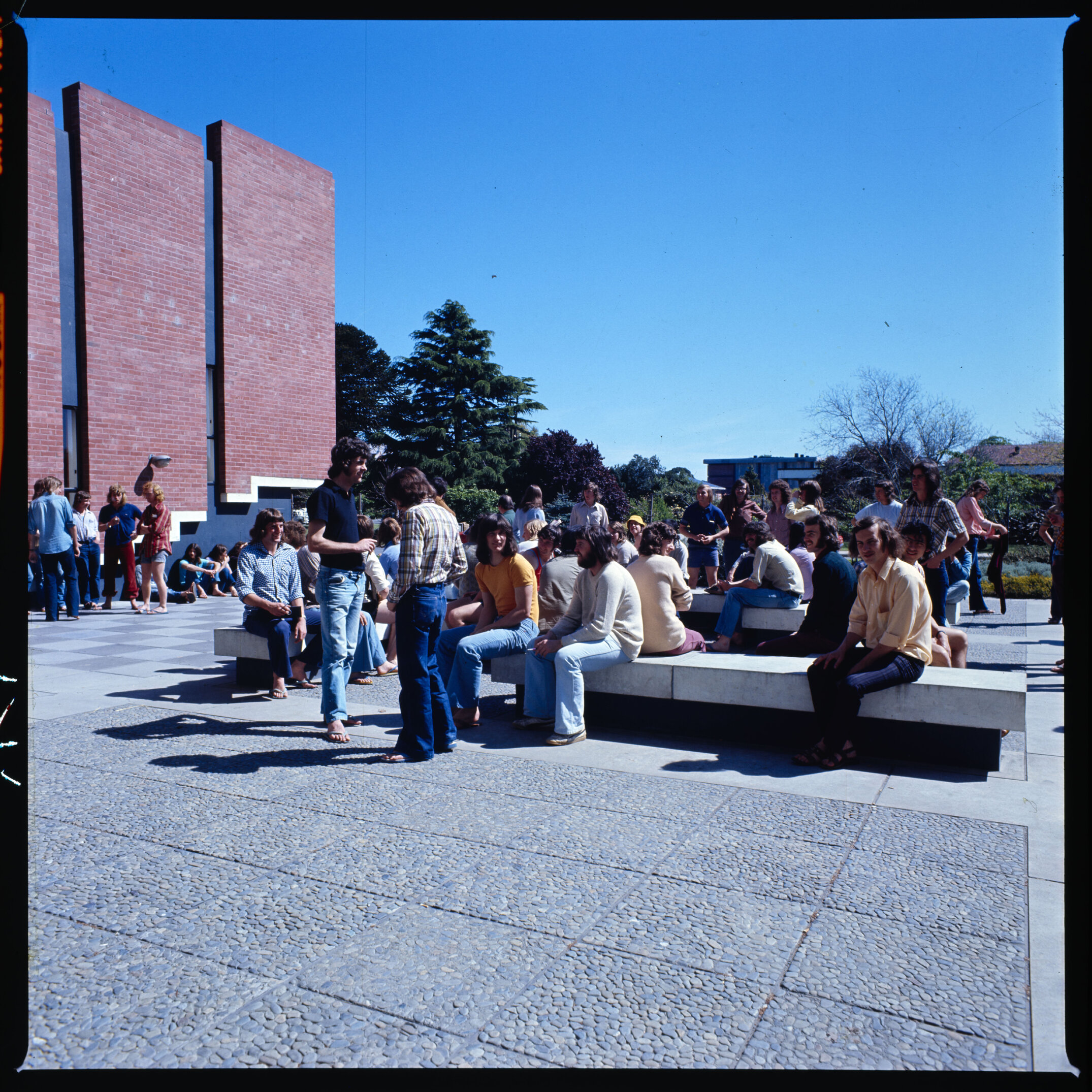 Early to mid-1970s Lincoln College students lounging in front of the Hilgendorf Building