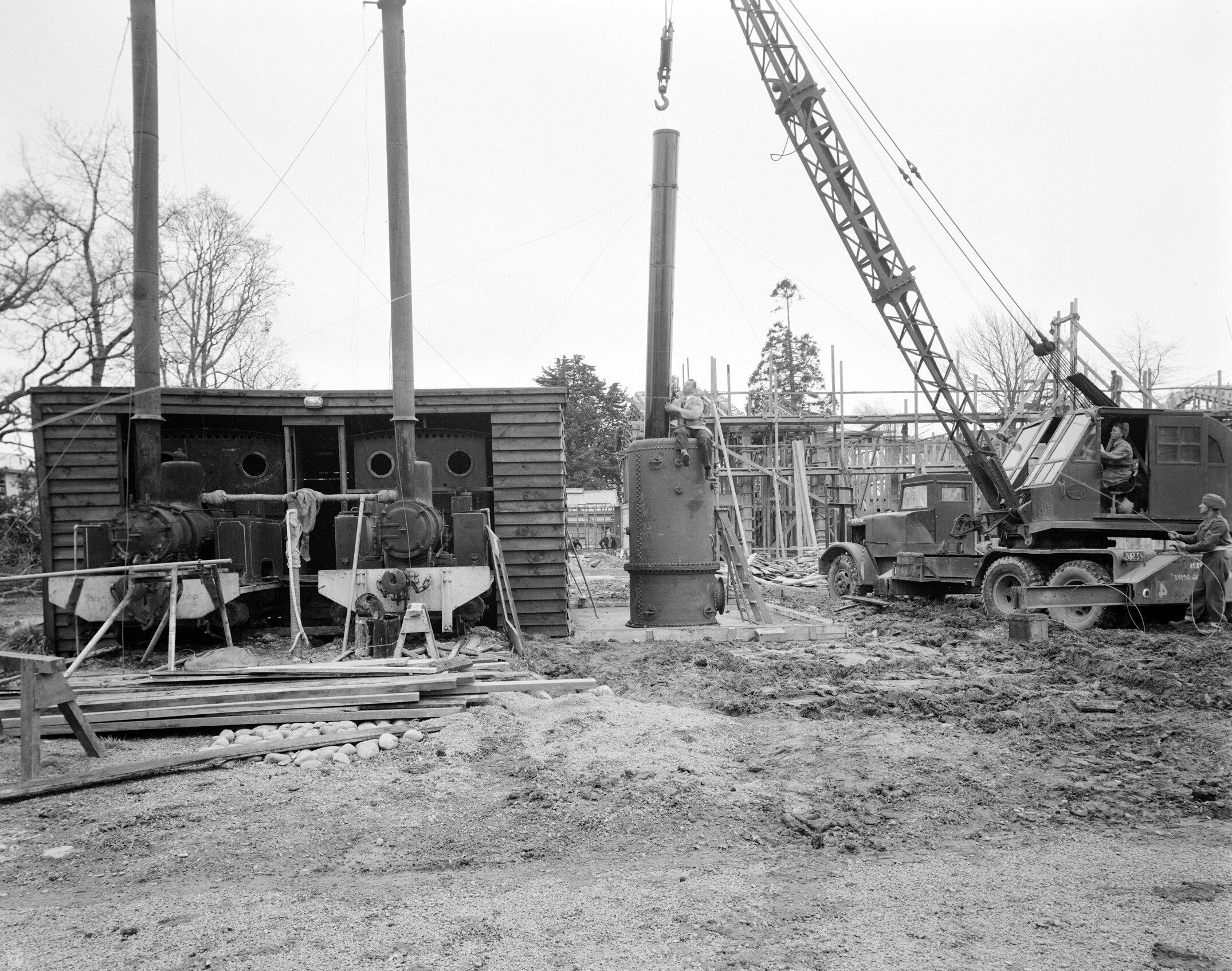 Two Public Works Department PWD locomotives being installed to supply heat and hot water to Hudson Hall between 1951-1954 (Blackmore Neg 5132)