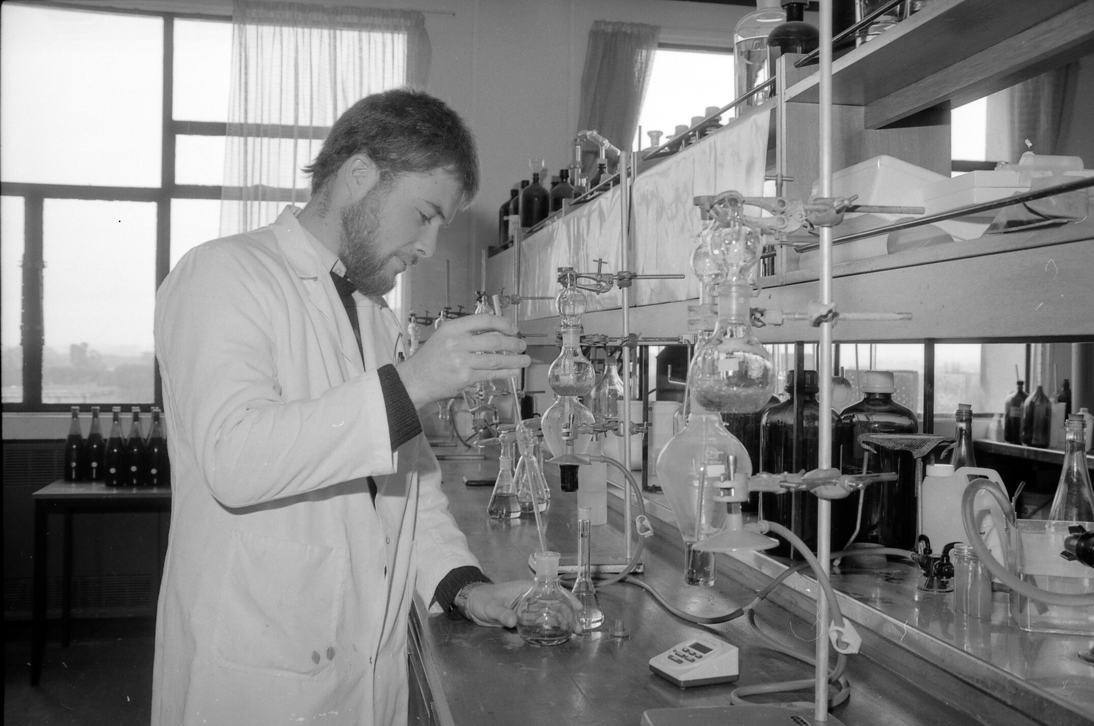 A researcher conducting wine analysis in the Lincoln College wine laboratory, July 1988 01