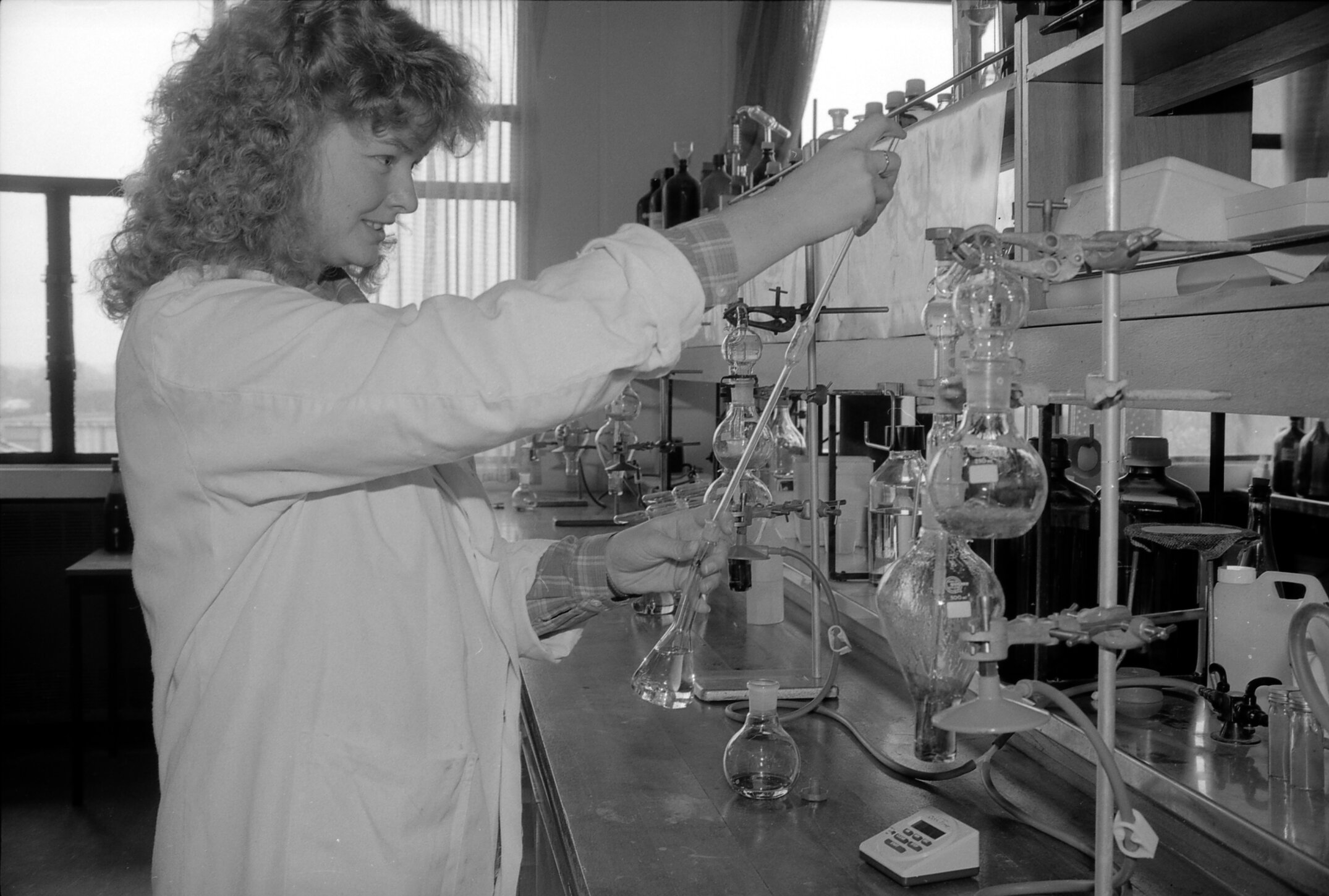 A researcher conducting wine analysis in the Lincoln College wine laboratory, July 1988 02