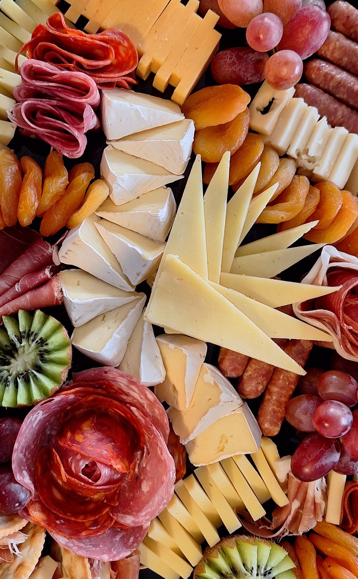 Charcuterie board with an assortment of cheese, meats, fruit and nuts 