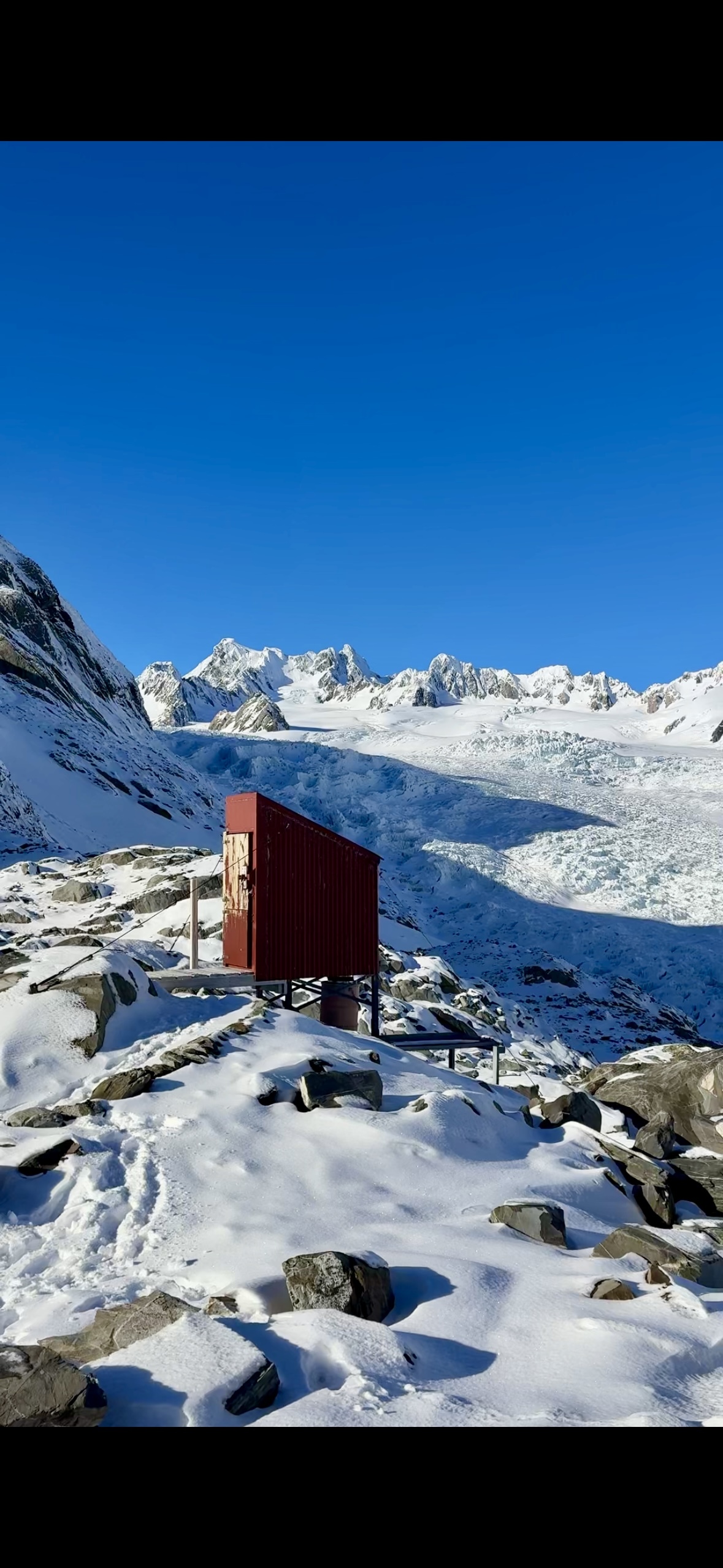 Almer Huts Long drop with Franz Josef Glacier in the background. 
