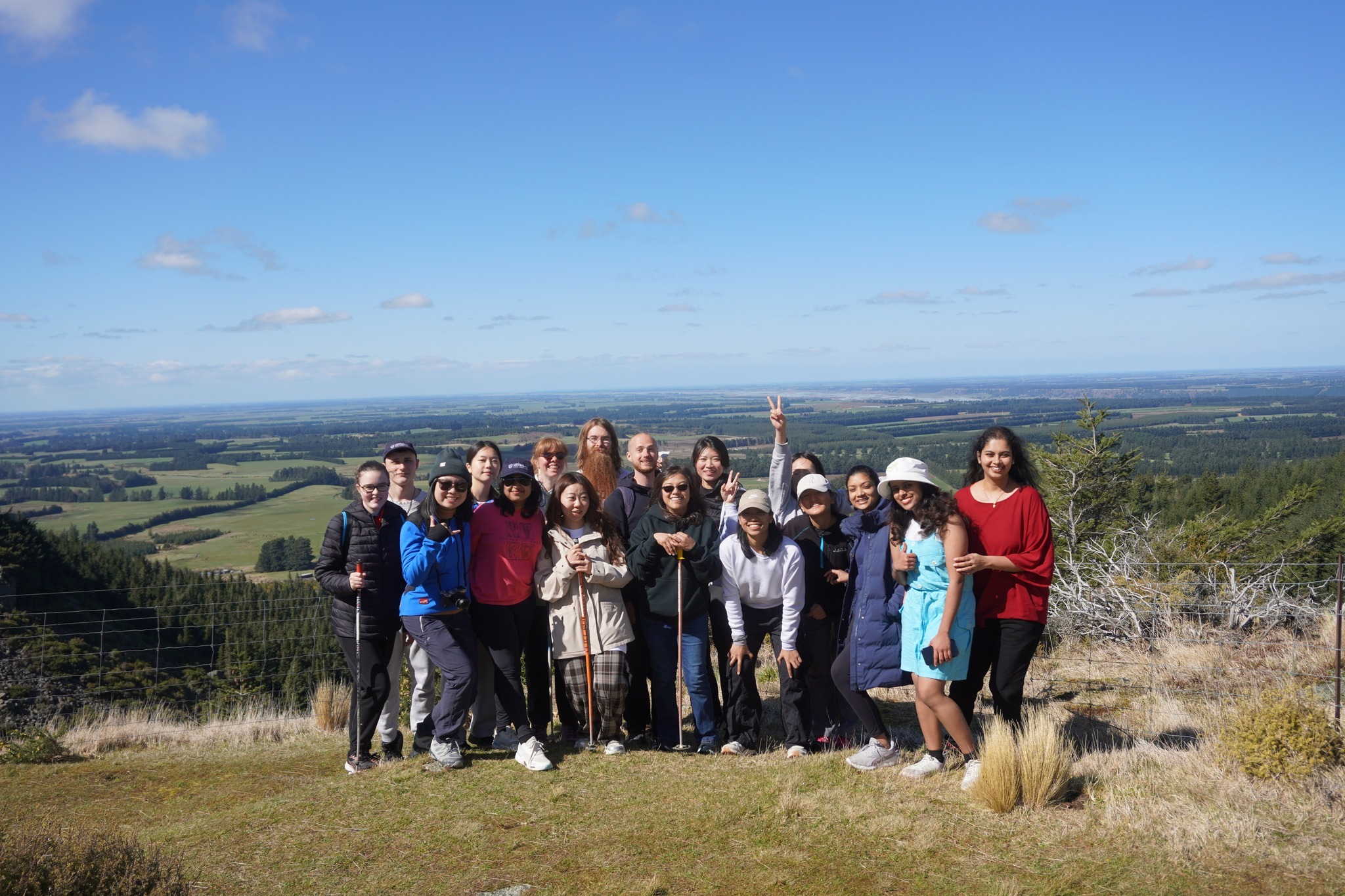Students gather for a group photo overlooking the landscape during a trip to Washpen Falls.