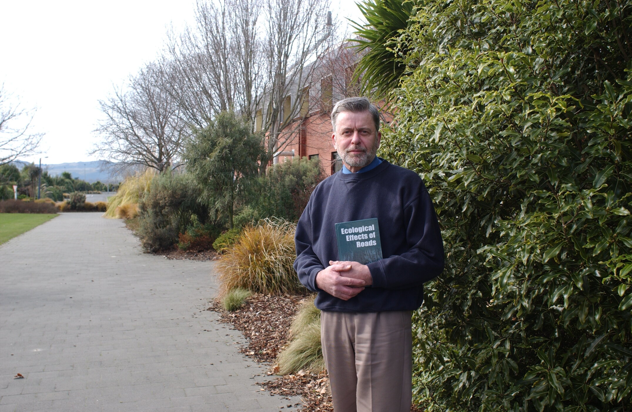 Professor Ian Spellerberg with a copy of Ecological Effects of Roads, photographed on 23 August 2002
