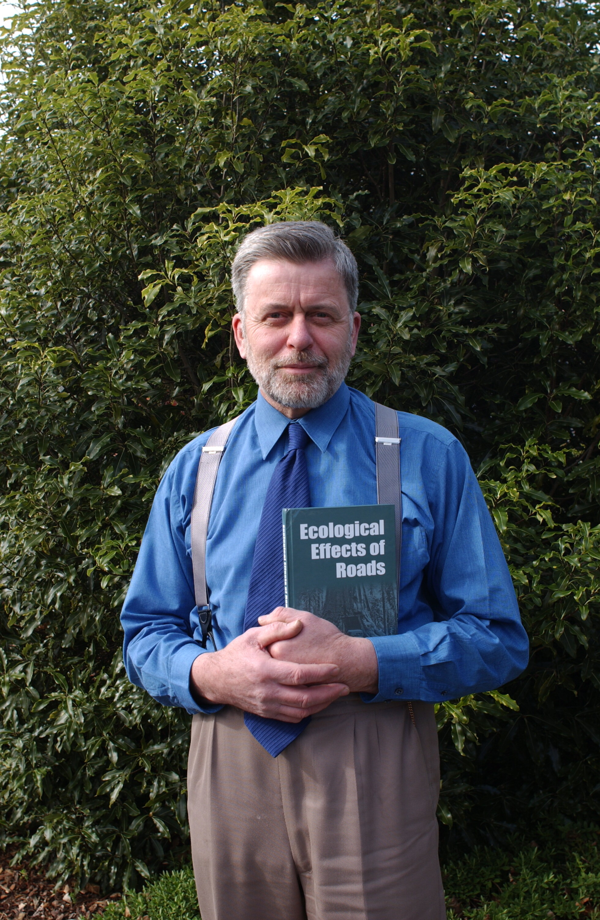 Professor Ian Spellerberg holding a copy of Ecological Effects of Roads, 23 August 2002.
