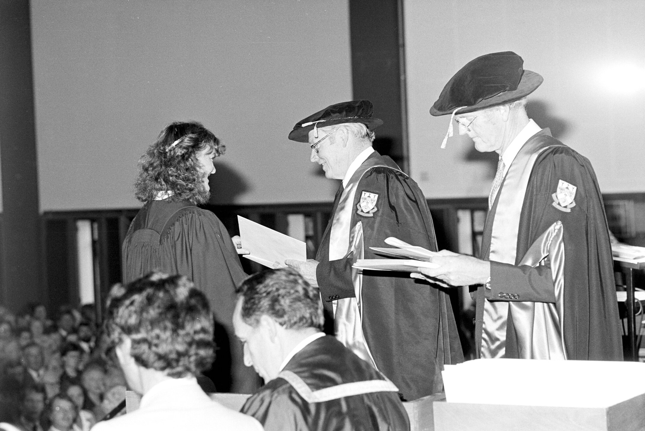 Sidney M. Hurst, Chairman of the College Council Presenting a Degree Certificate at Graduation Ceremony, 1981 01