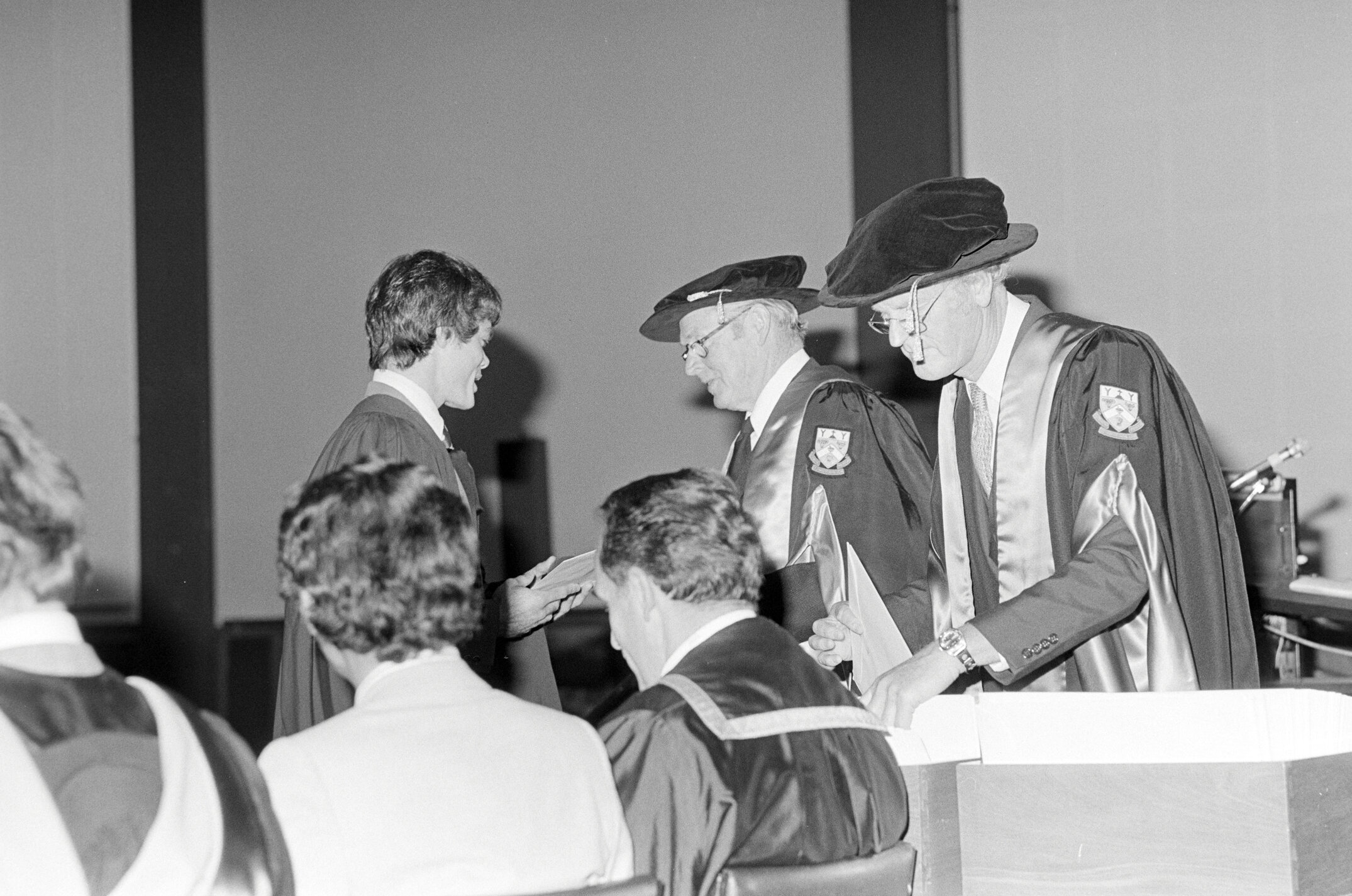 Sidney M. Hurst, Chairman of the College Council Presenting a Degree Certificate at Graduation Ceremony, 1981 03