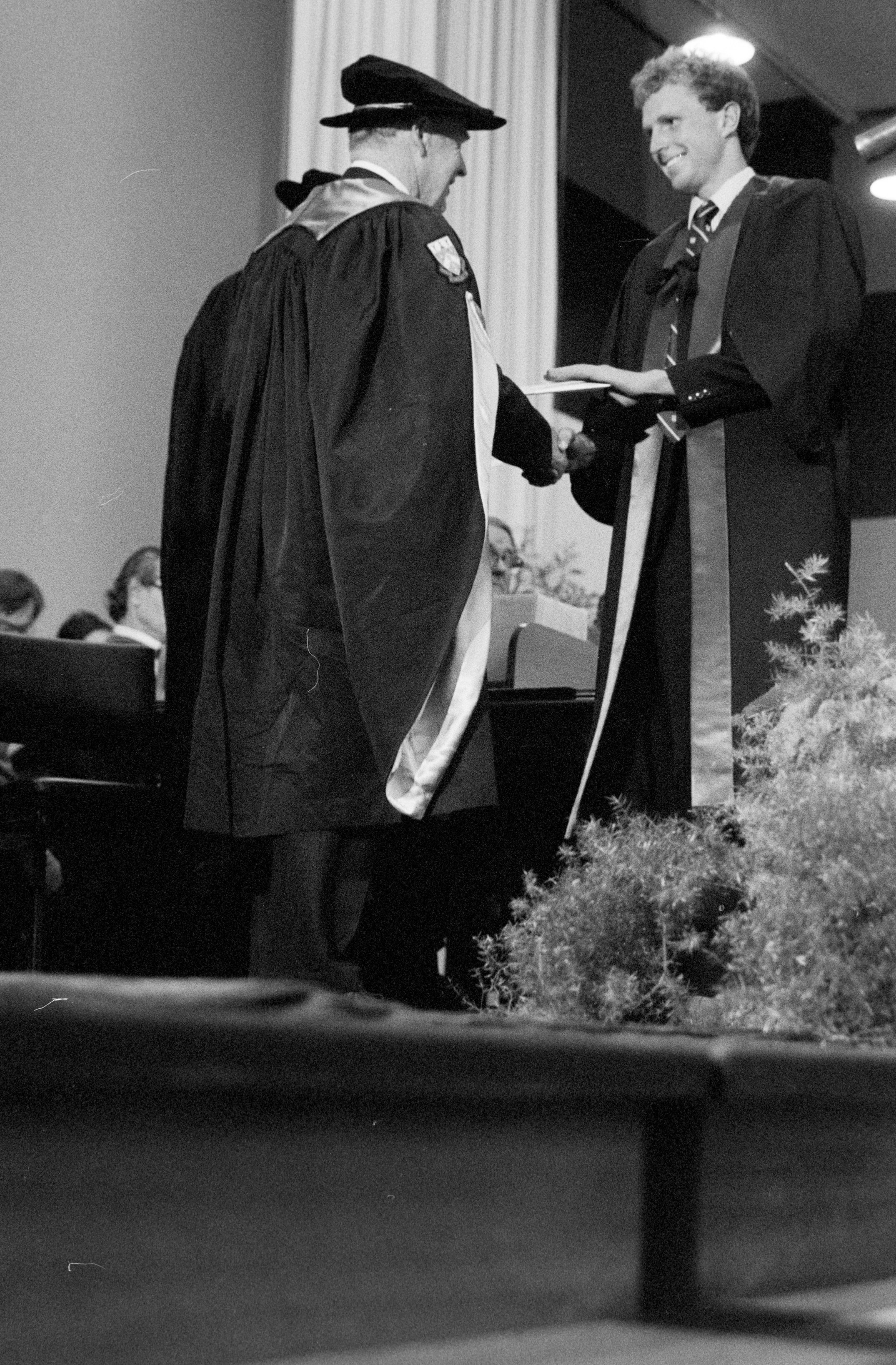 Graduate Receiving Degree Certificate from Sidney M. Hurst at the Lincoln College Graduation Ceremony, Gillespie Hall, 04 May 1984 01