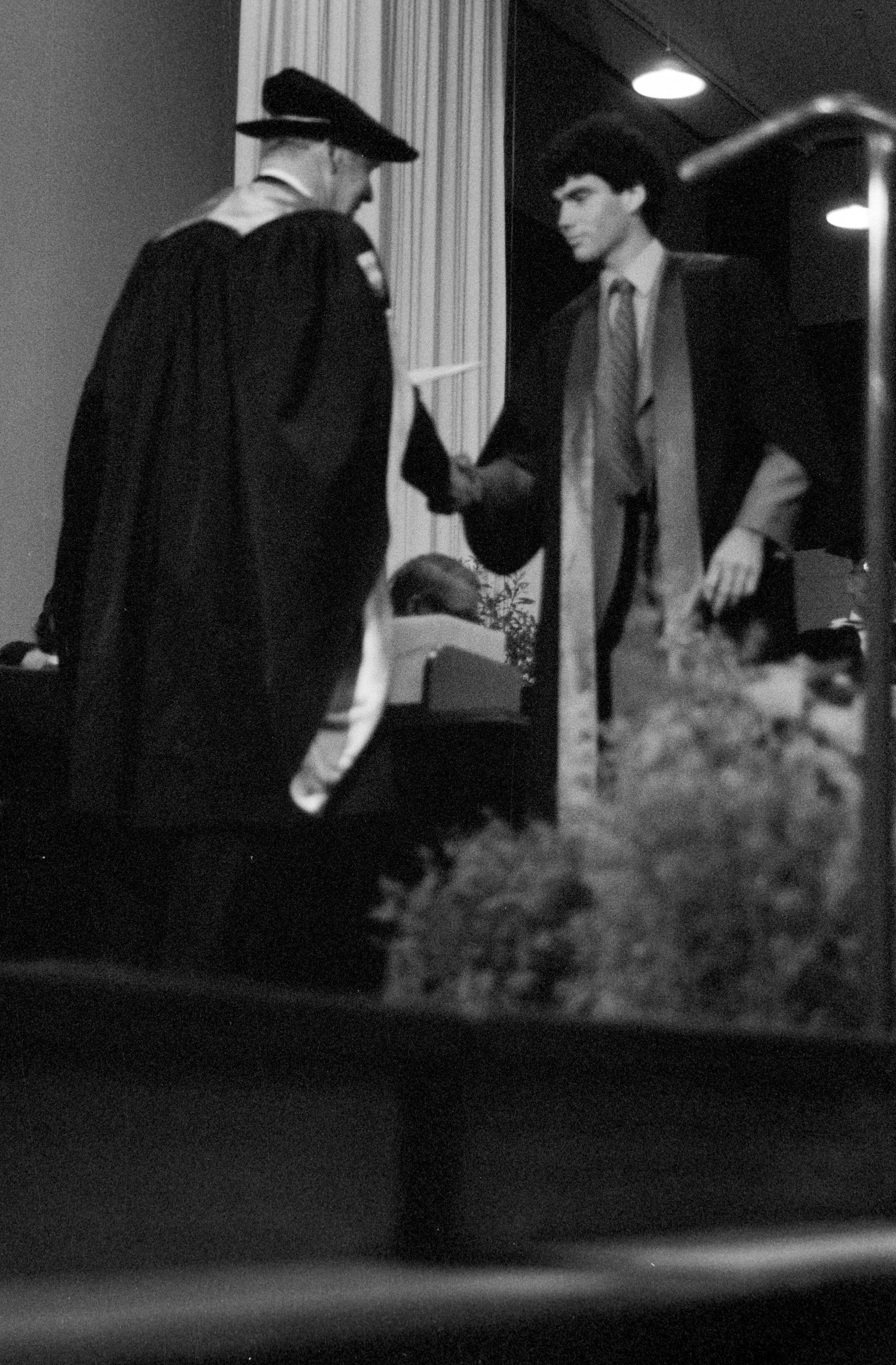 Graduate Awarded Degree Certificate by Sidney M. Hurst in Gillespie Hall, 04 May 1984 01