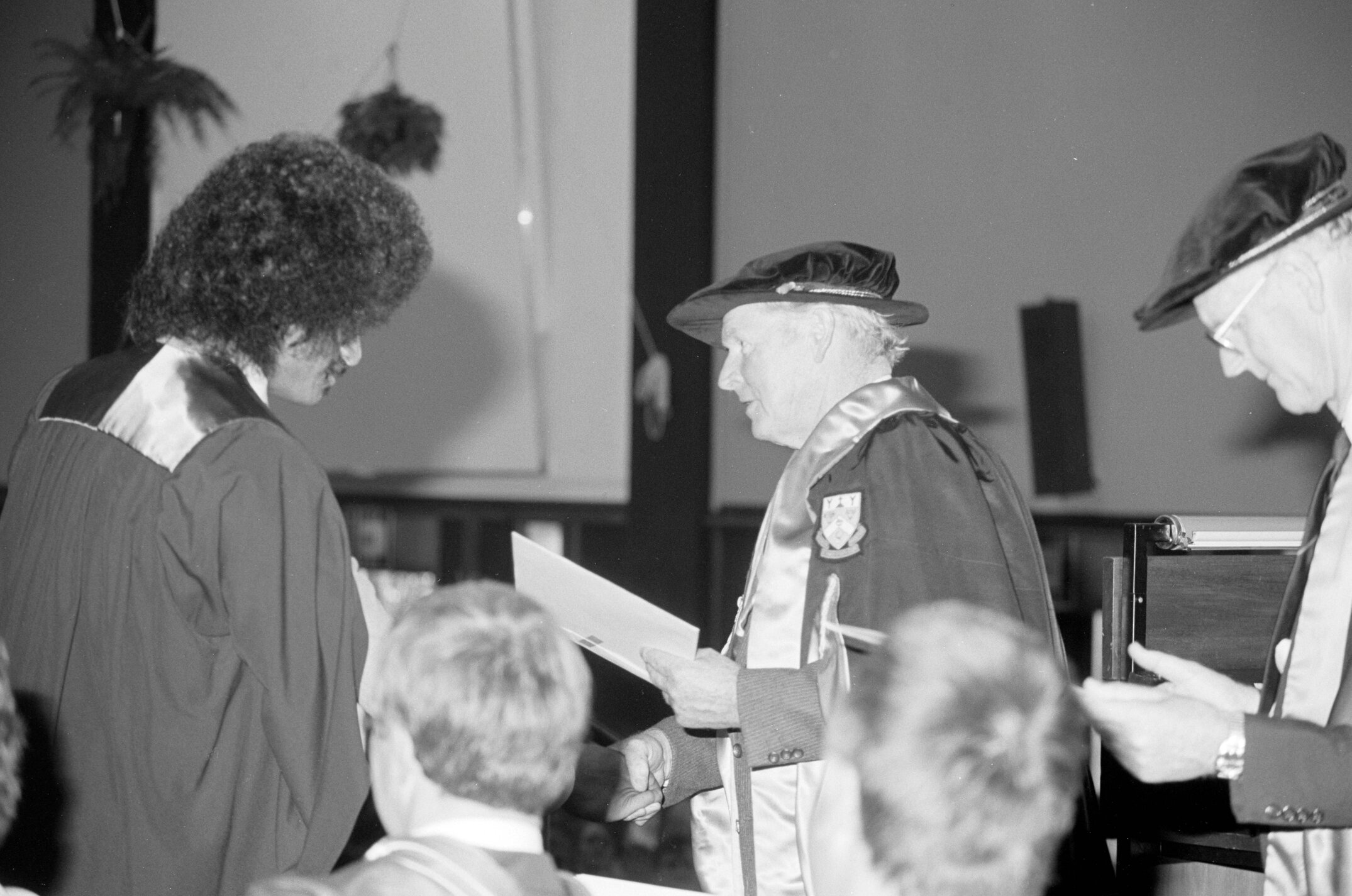 Sidney M. Hurst, Chairman of the College Council Presenting a Degree Certificate at Graduation Ceremony, 1985 06