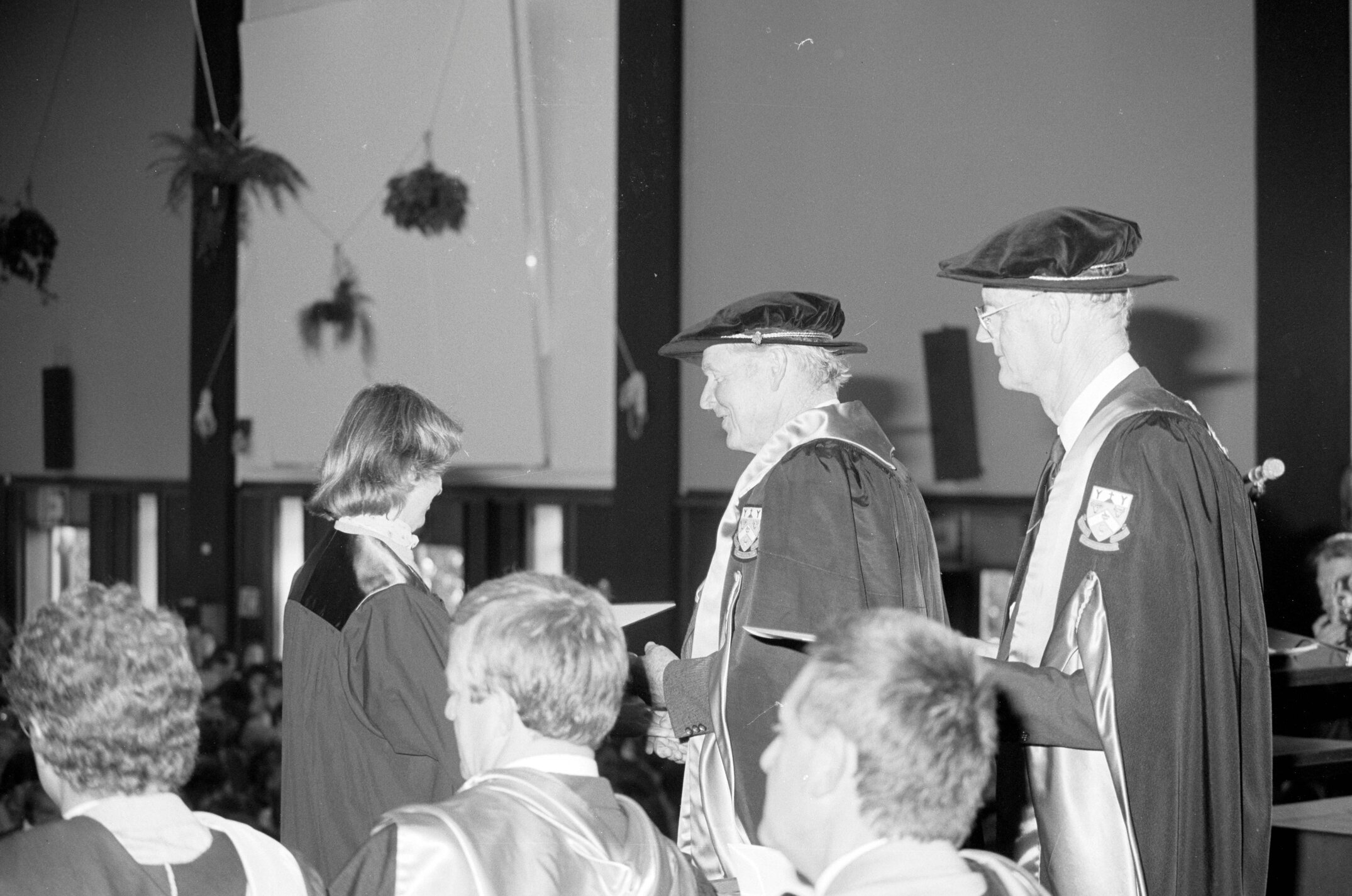 Sidney M. Hurst, Chairman of the College Council Presenting a Degree Certificate at Graduation Ceremony, 1985 01
