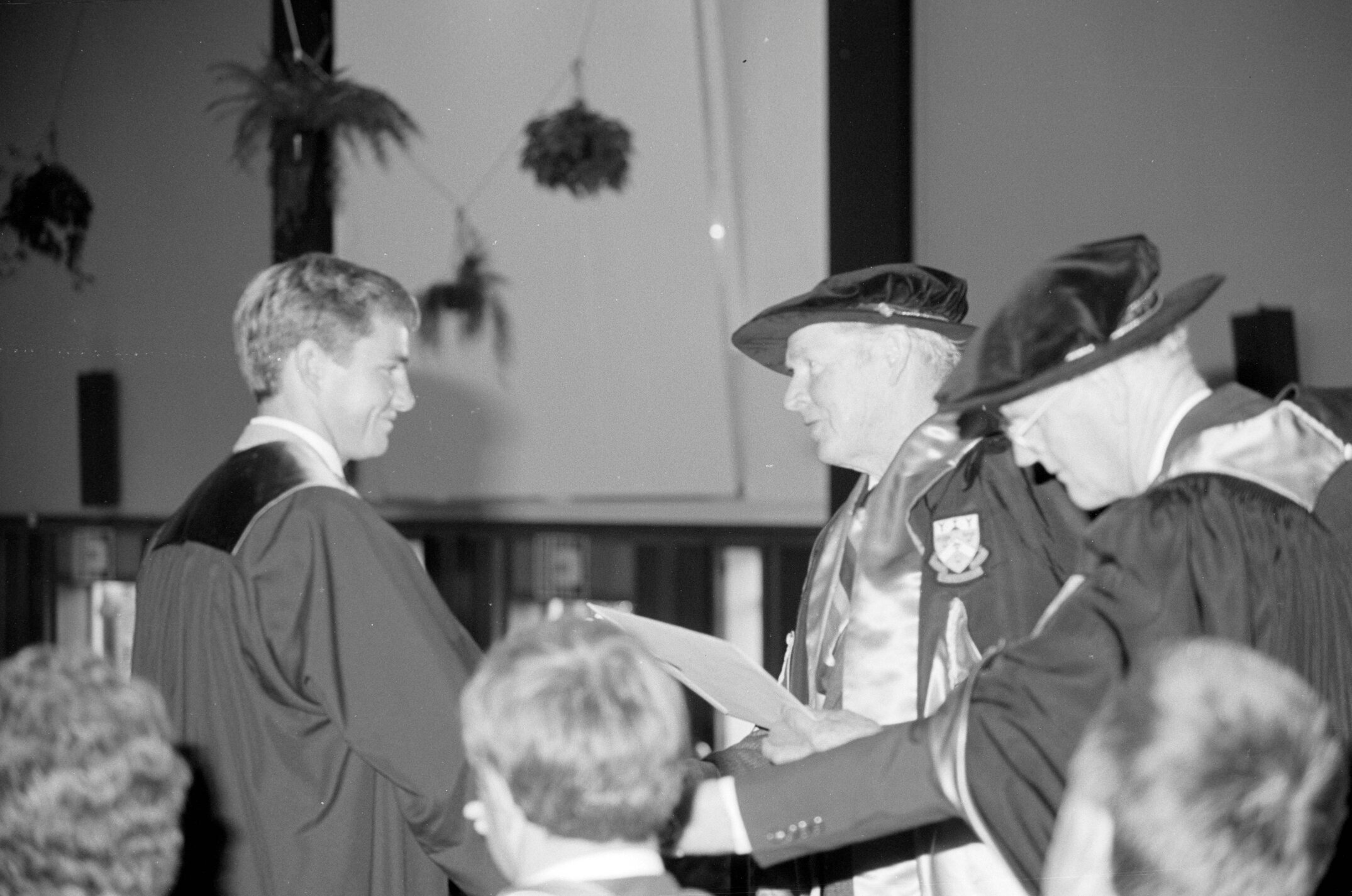 Sidney M. Hurst, Chairman of the College Council Presenting a Degree Certificate at Graduation Ceremony, 1985 02