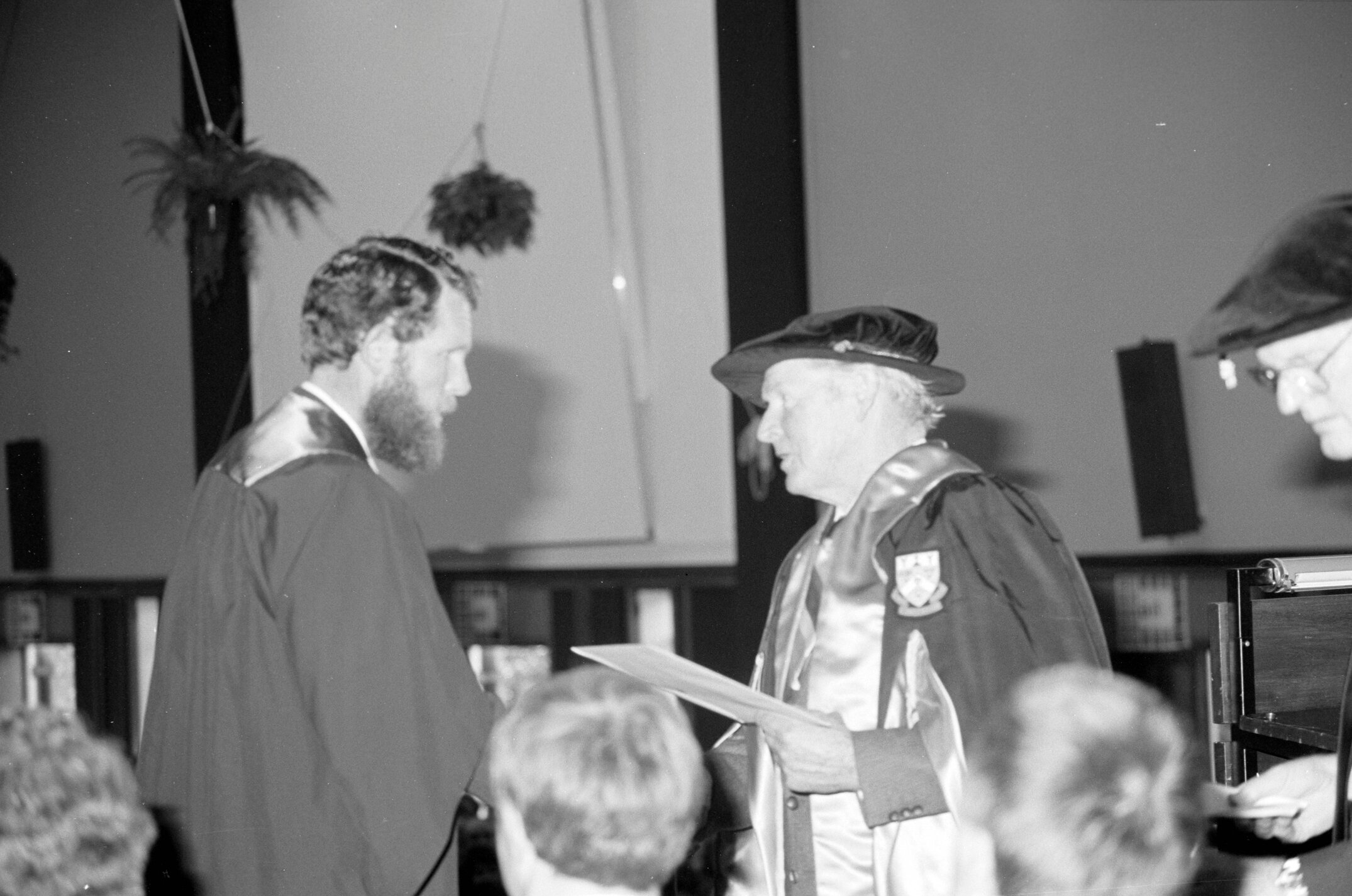 Sidney M. Hurst, Chairman of the College Council Presenting a Degree Certificate at Graduation Ceremony, 1985 03