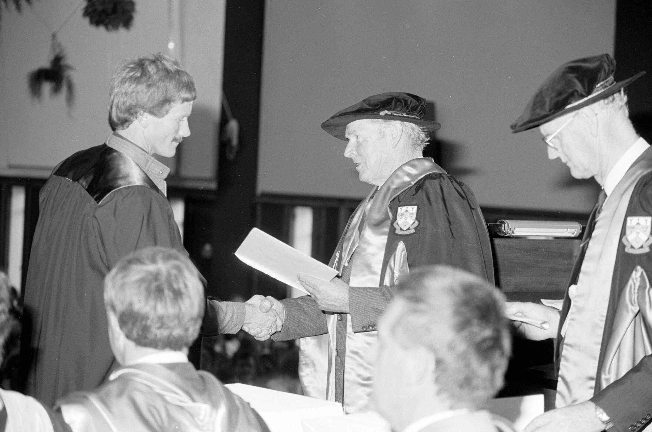 Sidney M. Hurst, Chairman of the College Council Presenting a Degree Certificate at Graduation Ceremony, 1985 04