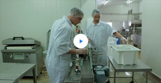 Cameron Ravenswood, left at work processing the sheep milk. (Country Calendar screenshot)