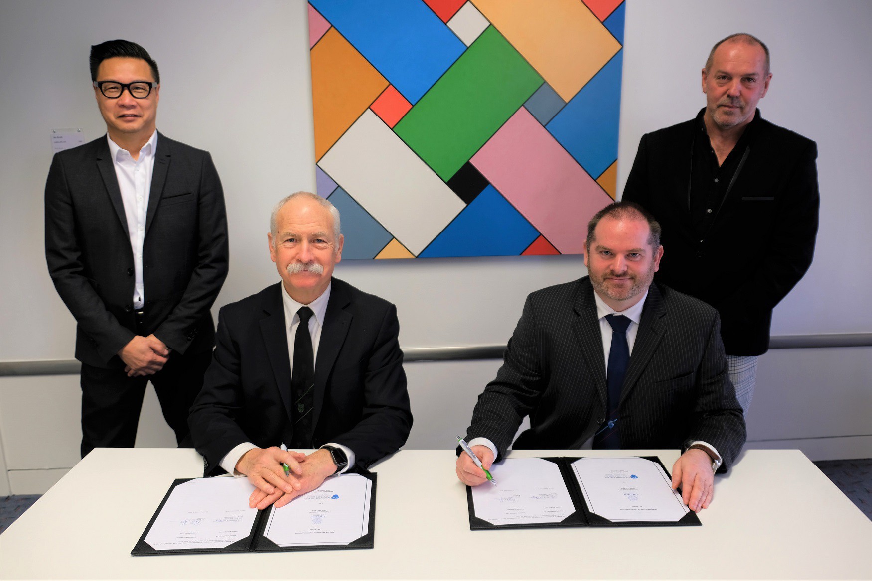 Pictured L to R: Roger Shew, Professor Bruce McKenzie (seated), Ronan Bass (seated), Steve Henderson