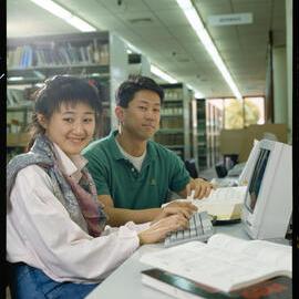 Students in the 1990s using a computer in the library