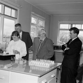 Members of the Board watching the whey agglutination test for Brucellosi being carried out (Blackmore Neg 5145)