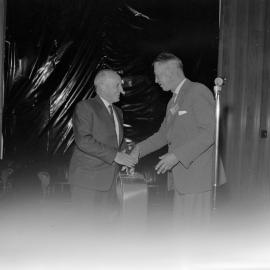 Mr J. Hunt, a committee member and past chairman of the Lincoln College Farmers’ Conference, making a presentation to Mr L. H. McCaskill, Secretary of the Conference, 1961