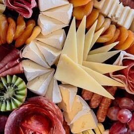 Charcuterie board with an assortment of cheese, meats, fruit and nuts 
