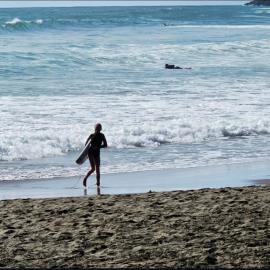 Surfers in Motion at Piha Beach, New Zealand