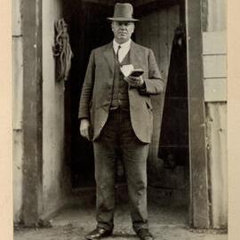 G. A. Willis Standing at the Doorway of a College Farm Building, 1917