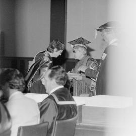 Chancellor Jean M. Herbison Presenting a Degree Certificate at Graduation, 1981