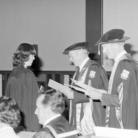 Sidney M. Hurst, Chairman of the College Council Presenting a Degree Certificate at Graduation Ceremony, 1981 04