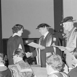 Donald W. Bain, Chairman of the College Council Presenting a Degree Certificate at Graduation Ceremony, 1979