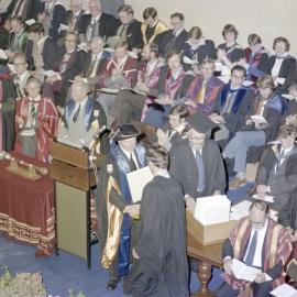 Sidney M. Hurst, Chairman of the College Council Presenting a Degree Certificate at Graduation Ceremony, 09 May 1980