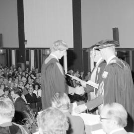 Sidney M. Hurst, Chairman of the College Council Presenting a Degree Certificate at Graduation Ceremony 07 May 1982