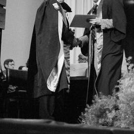 Graduate Receiving Degree Certificate from Sidney M. Hurst at the Lincoln College Graduation Ceremony, Gillespie Hall, 04 May 1984 02