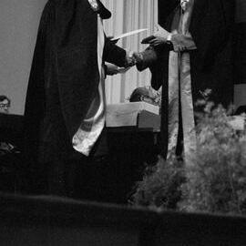 Graduate Awarded Degree Certificate by Sidney M. Hurst in Gillespie Hall, 04 May 1984 02