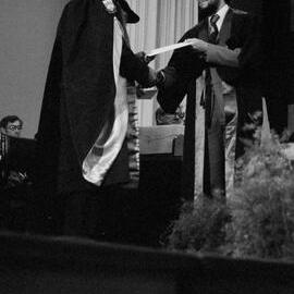Graduate Awarded Degree Certificate by Sidney M. Hurst in Gillespie Hall, 04 May 1984 03