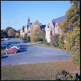 Ivey Hall and Memorial Hall. Cars are parked in front of the buildings, 1976