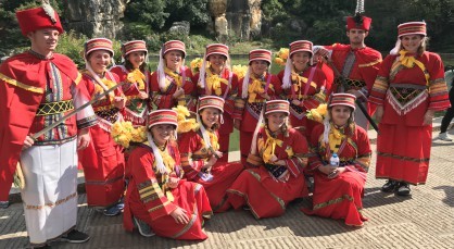 The Lincoln students try on some traditional dress in China.