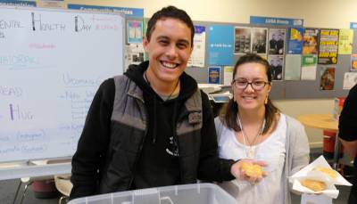 Maui Duley and Mishael Coulter from Lincoln University’s Te Awhioraki: Māori Students’ Association dish out some fried bread treats as part of Universities Mental Health Day.
