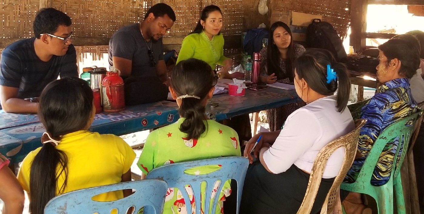 Randel Esnard, rear centre, talks to farmers in Myanmar.