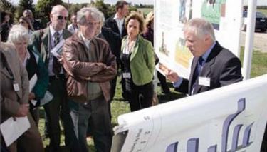Soil scientist Professor Keith Cameron (right) explains nitrification inhibitor research on Lincoln University's Dairy Farm to President Vázquez. Interpreter Mrs Trinidad Ott between them.