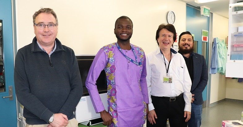 PhD student Aghogho Ohwofasa and his supervisors, Drs Chris Winefield, Stephen On and Damir Torrico, in front of a new sequencer machine that will play a key role in Aghogho’s research.